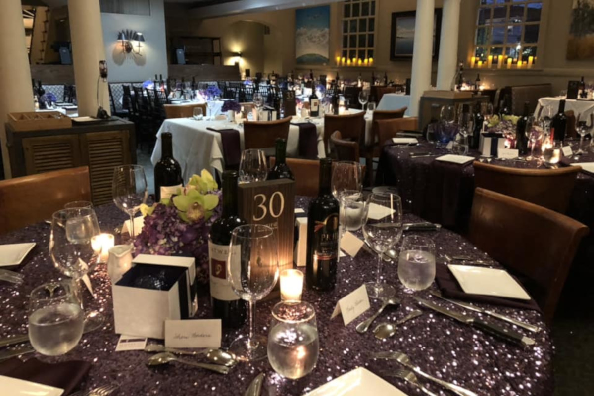 Tables ready for guests, bottles of wine on the table
